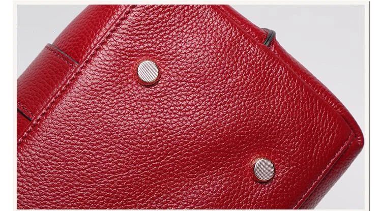 Premium first-layer cowhide leather shoulder bag with adjustable strap, spacious interior, and classic fashion design