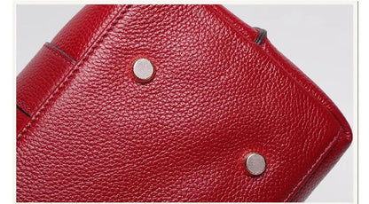 Premium first-layer cowhide leather shoulder bag with adjustable strap, spacious interior, and classic fashion design