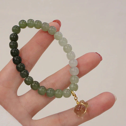 Elegant Hetian jade barrel bead bracelet with gradual colour transition, handcrafted with premium materials for a sophisticated style.