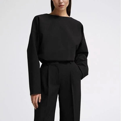 Elegant and sophisticated women's two-piece office suit with long sleeve top and wide-leg pants in a neutral colour palette