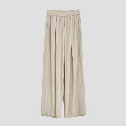 Pleated wide-leg high-waisted trousers in a herringbone plaid pattern, featuring a flattering silhouette and comfortable cotton-linen blend