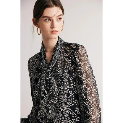 Elegant black silk blouse with unique bow collar, designed for a flattering fit and all-day comfort.