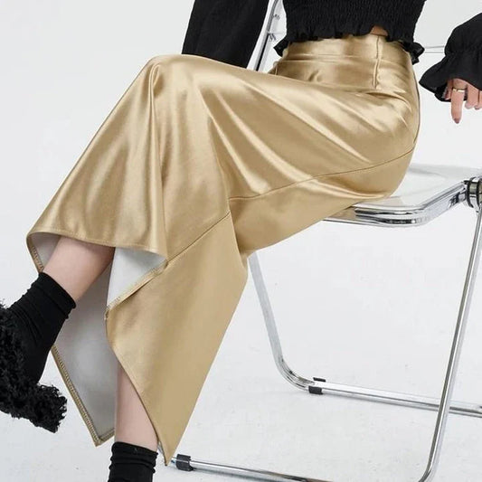 Luxurious silver satin maxi skirt with high-waist design and chic back split for elegant and versatile style.