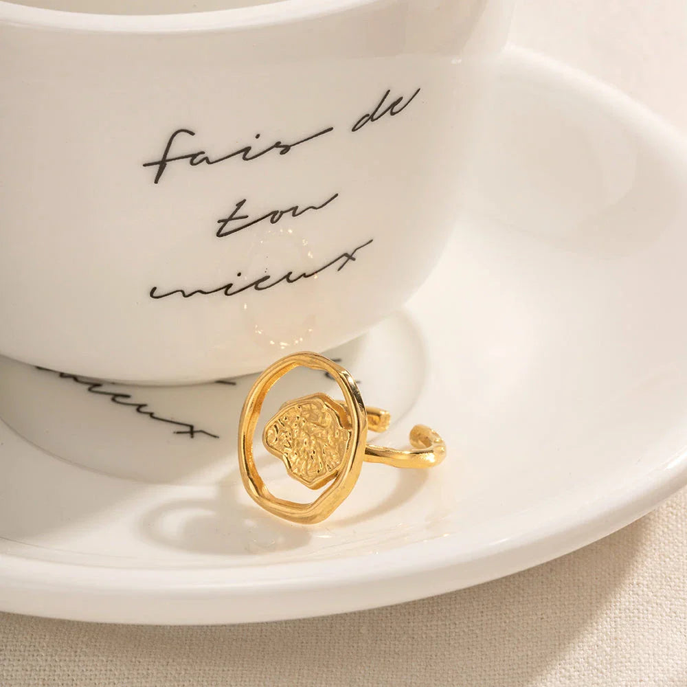 Elegant 18K gold-plated stainless steel ring with intricate hollow-carved design and vintage-inspired charm
