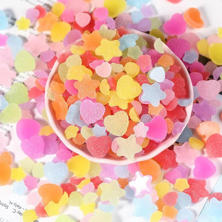 Heart and star-shaped nail charms with candy-inspired designs for creating unique and eye-catching nail art