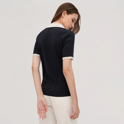 Stylish silk knit polo shirt in navy blue, featuring a slim fit design, contrasting trim, and a feminine v-neckline for refined British elegance.
