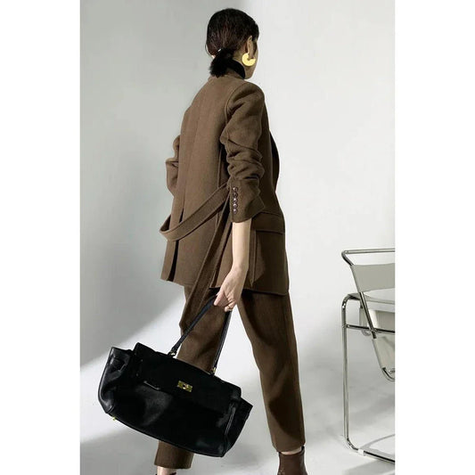 Elegant autumn-winter woollen pant suit with belted jacket and warm trousers for women