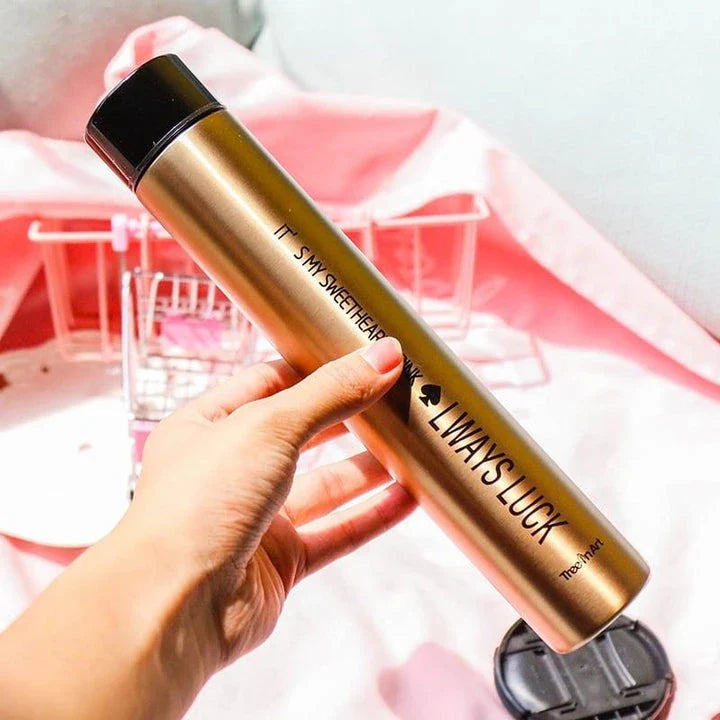 Elegant and slim stainless steel travel thermos in gold colour, with a straight cup design for comfortable one-handed use