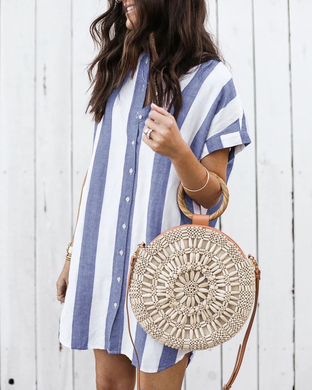 Casual striped short sleeve shirt dress in pink and blue colours, featuring a relaxed, flowing silhouette and button-down closure