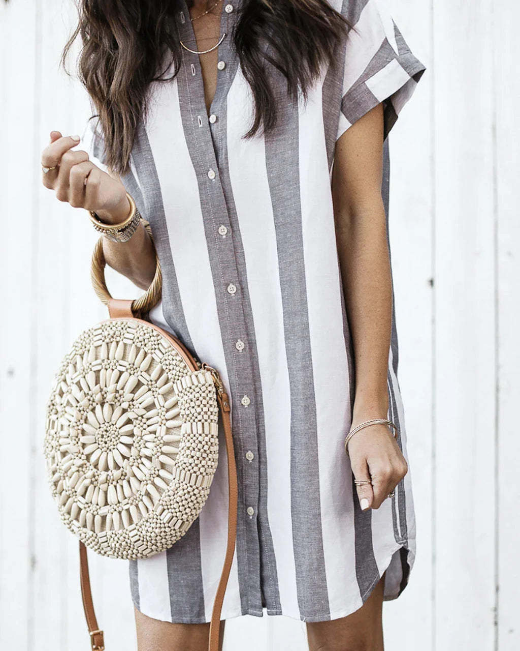 Casual striped short sleeve shirt dress in pink and blue colours, featuring a relaxed, flowing silhouette and button-down closure