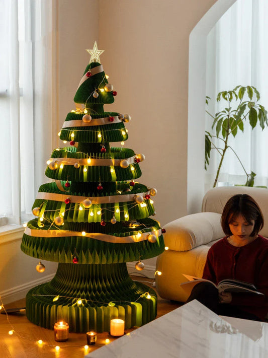 A beautifully crafted origami Christmas tree decoration in a Nordic-inspired style, with a warm, glowing illumination