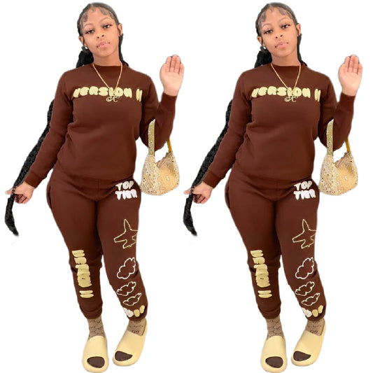 Stylish two-piece casual sports outfit for women, featuring a relaxed top and comfortable trousers in black and brown colors.