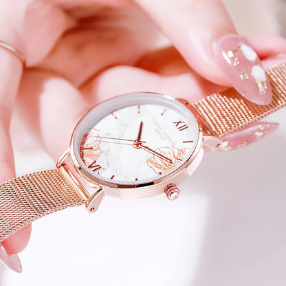 Elegant French ladies' fashion watch with stainless steel case and leather strap, featuring a white dial and classic design