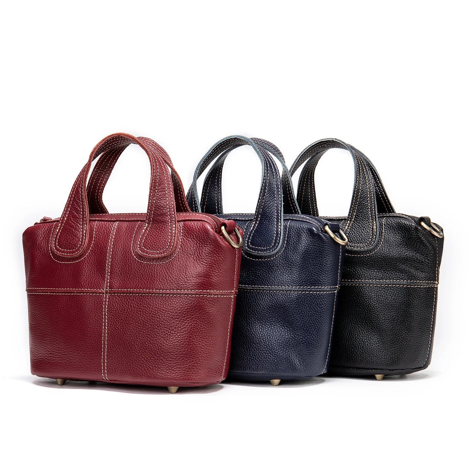 Premium leather shoulder bag for women in red, blue, and black colours with spacious interior and comfortable strap