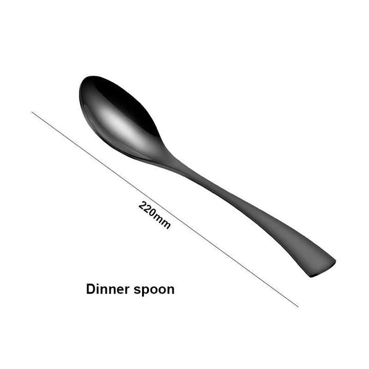 A stylish set of black stainless steel flatware, including a teaspoon, knife, and fork, on a white background.