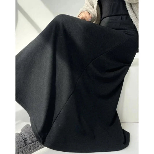 Elegant high-waist knitted skirt in black, showcasing a flattering A-line silhouette and ankle-length cut for the modern British woman.