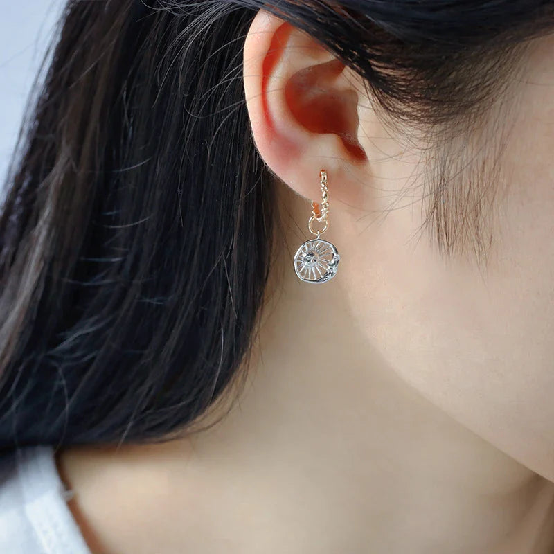 Elegant sterling silver sun and moon earrings with a refined geometric design