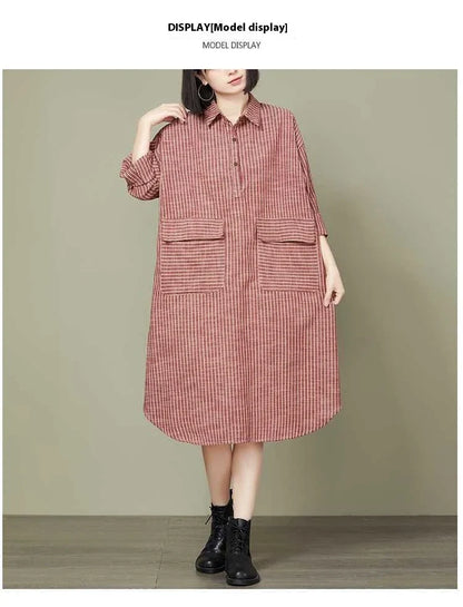 Plus-size women's dress with a striped pattern, asymmetric skirt, and long loose sleeves