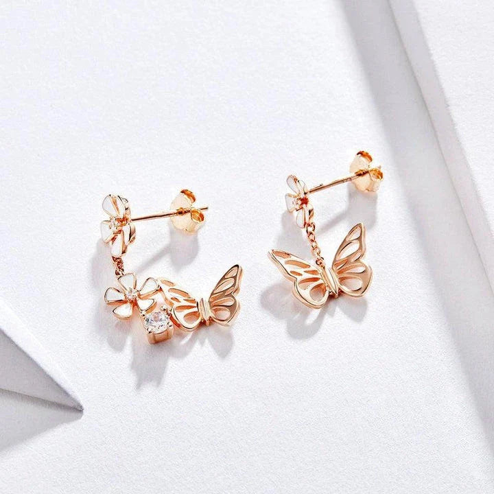 Pair of silver earrings featuring a butterfly-shaped floral design with sparkling white crystals, inspired by the enchanting Forest Series