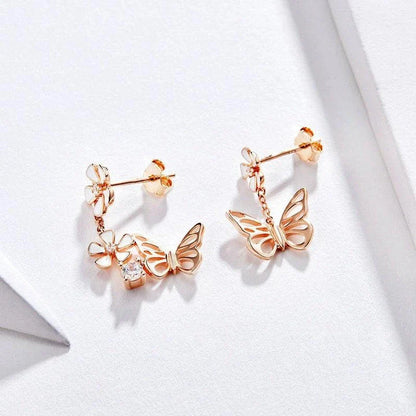 Pair of silver earrings featuring a butterfly-shaped floral design with sparkling white crystals, inspired by the enchanting Forest Series