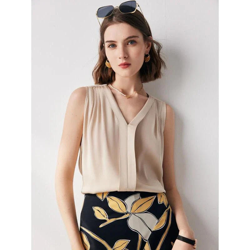 Elegant sleeveless silk blouse in a vibrant blue colour, designed for a sophisticated summer style