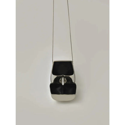 Elegant silver acrylic evening clutch bag with stylish chain strap for versatile carrying