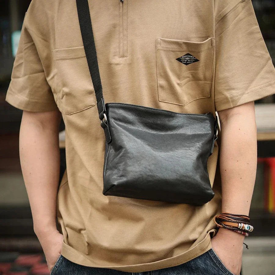 Premium black leather shoulder bag with horizontal zipper closure, featuring a spacious interior and versatile design for the modern British gentleman