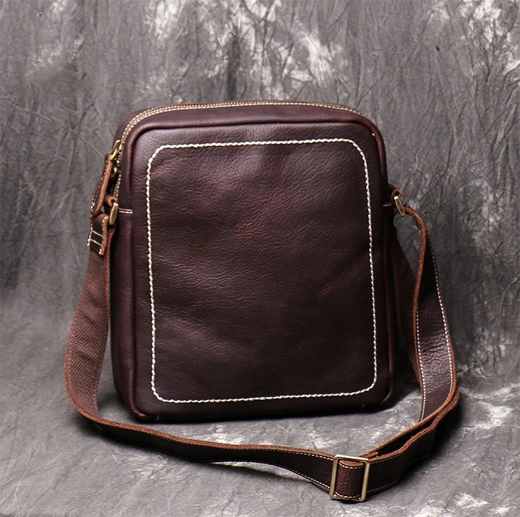 A premium cowhide leather satchel bag with a single shoulder strap, designed for the discerning British gentleman