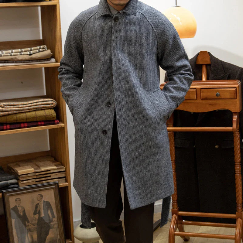Premium mid-length herringbone wool coat in a sophisticated dark grey hue, featuring a tailored slim-fit silhouette for a refined, stylish appearance.