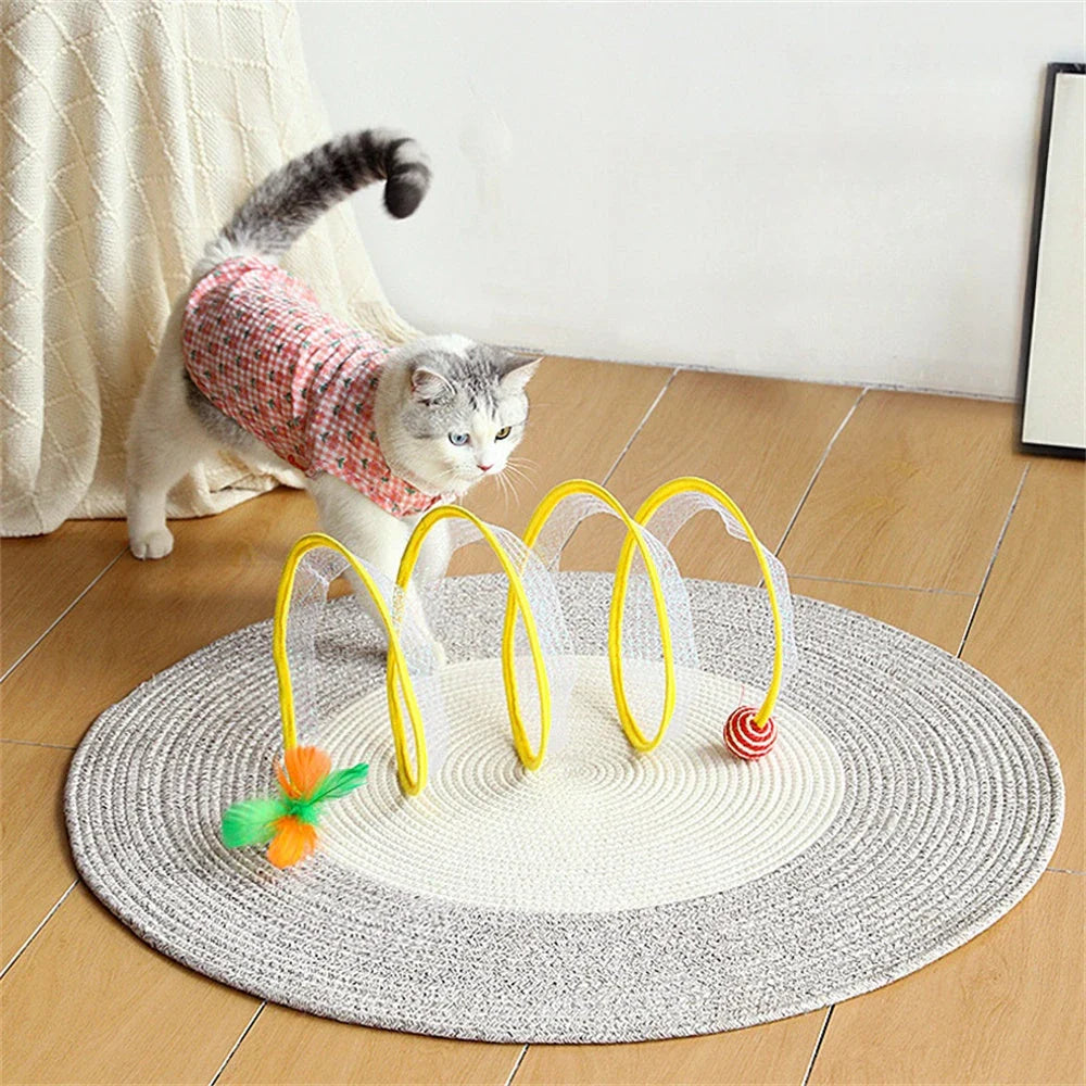 Folding cat play tunnel with various toys like balls, feathers, and mice attached to the sides
