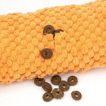 A plush snail-shaped snuffle mat toy with hidden treat pockets, designed to stimulate a dog's natural foraging instincts.