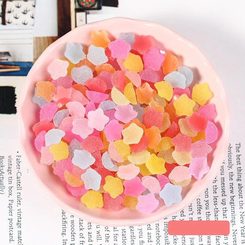 Heart and star-shaped nail charms with candy-inspired designs for creating unique and eye-catching nail art