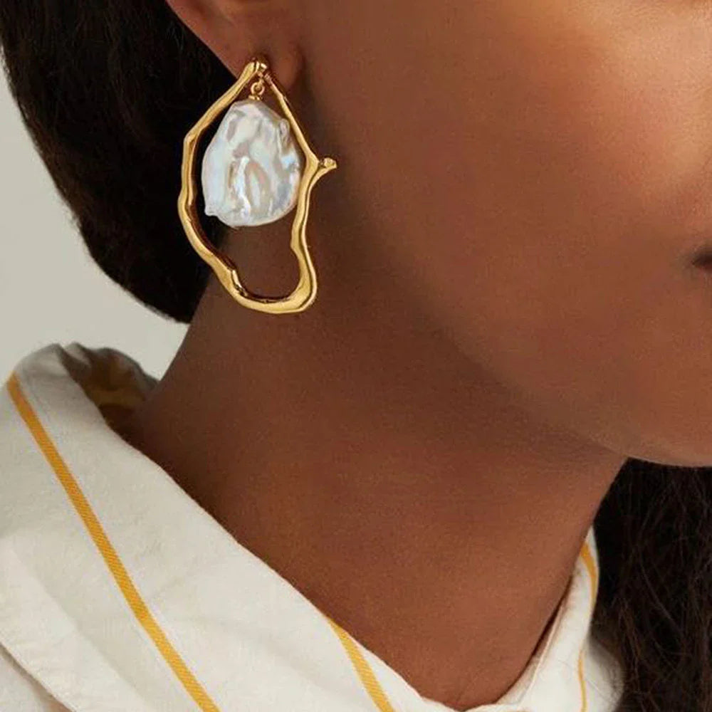 Irregular pearl earrings in a gold colour, featuring a unique and stylish design for versatile wear