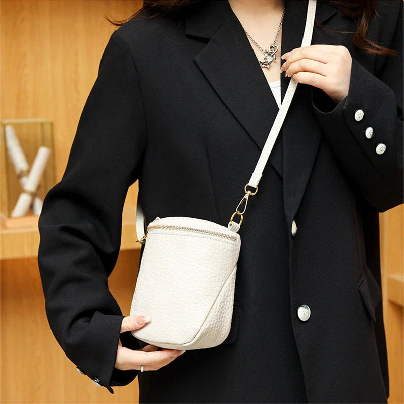 Elegant leather crossbody bag with adjustable strap, multiple pockets, and premium cowhide construction for the modern British woman