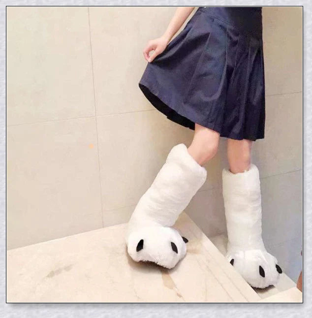 Cosy and whimsical oversized bear paw winter slippers with a plush, fluffy design and non-slip sole for secure indoor wear