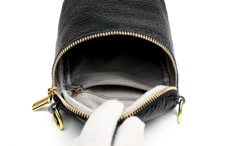 Elegant leather crossbody bag with adjustable strap, multiple pockets, and premium cowhide construction for the modern British woman