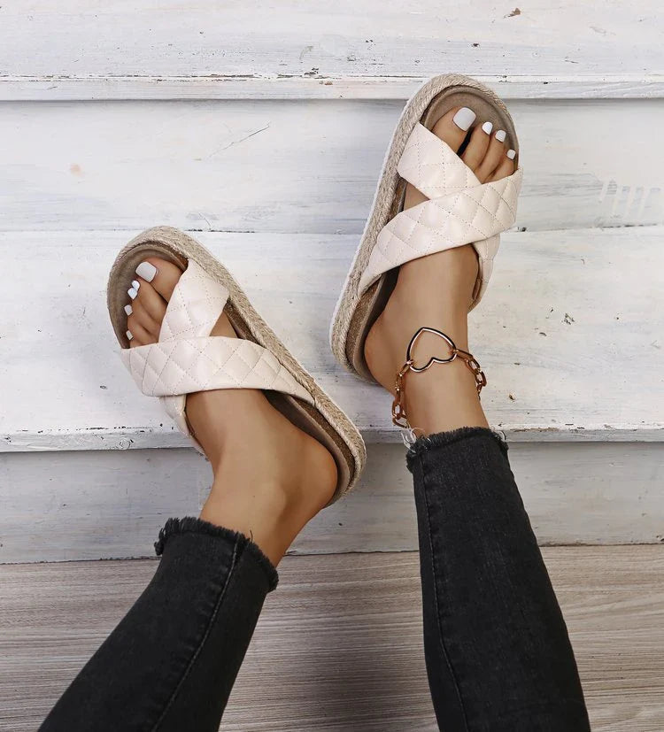 Elegant cross-toe platform sandals and slippers in a neutral creamy white hue, showcasing a contemporary and refined design for the discerning woman