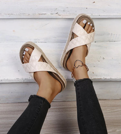 Elegant cross-toe platform sandals and slippers in a neutral creamy white hue, showcasing a contemporary and refined design for the discerning woman