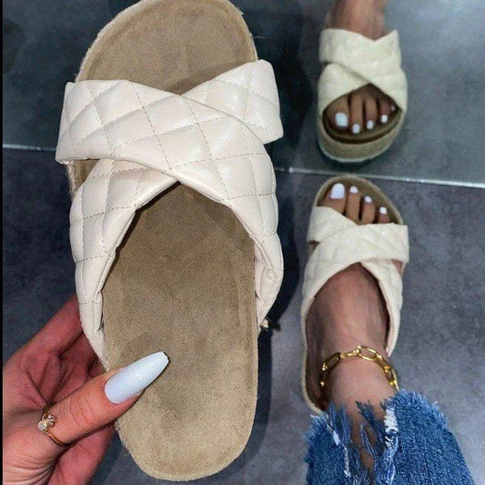 Elegant cross-toe platform sandals and slippers in a neutral creamy white hue, showcasing a contemporary and refined design for the discerning woman