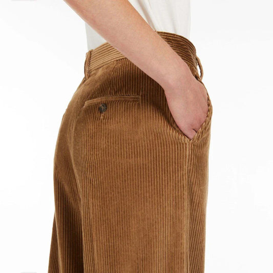 A pair of high-waist, wide-leg corduroy trousers in a classic red colour, designed for the modern British woman's wardrobe.