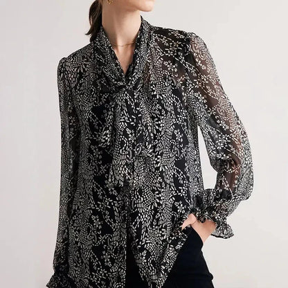 Elegant black silk blouse with unique bow collar, designed for a flattering fit and all-day comfort.