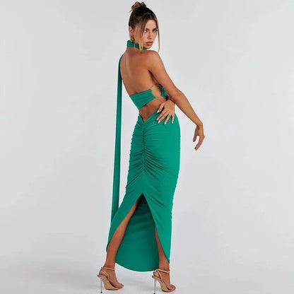 Glamorous backless cocktail dress set with halter-neck crop top and flowing maxi skirt in green colour