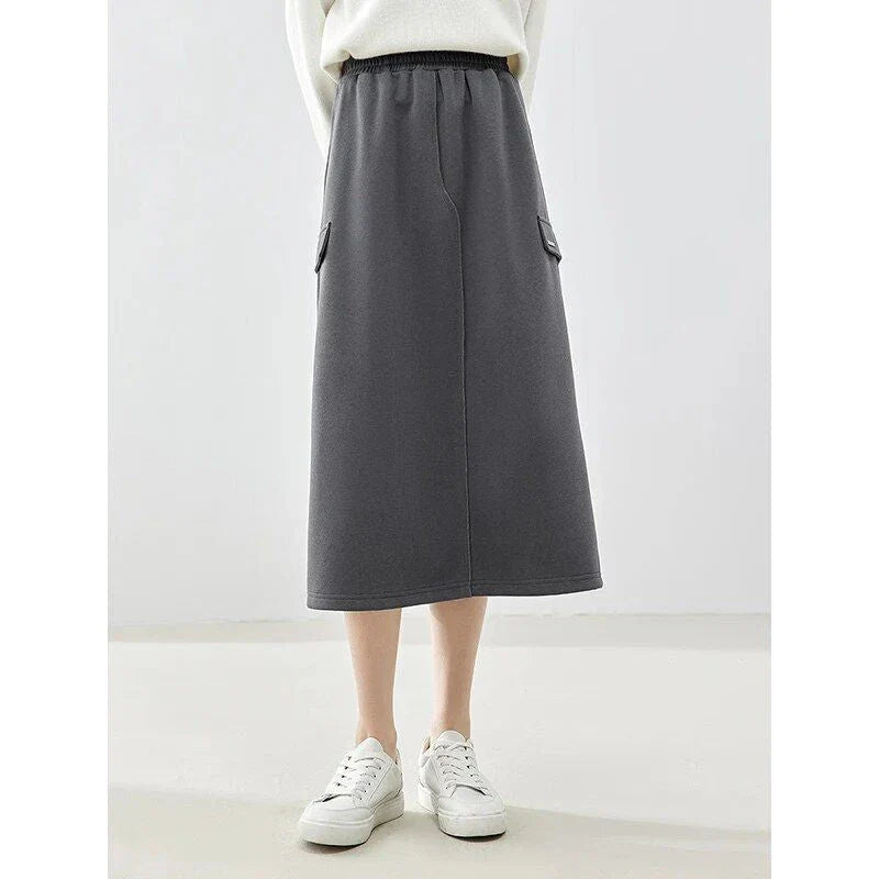 Elegant dark grey midi skirt with subtle sequin detailing, suitable for autumn and winter wear