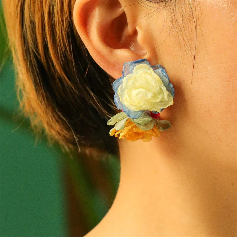 Exquisite handcrafted floral earrings with delicate fabric flowers and alloy accents, showcasing timeless British elegance