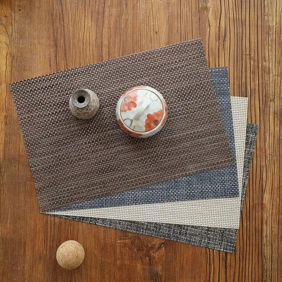Stylish and durable waterproof placemats in black, protecting a dining table from spills and stains