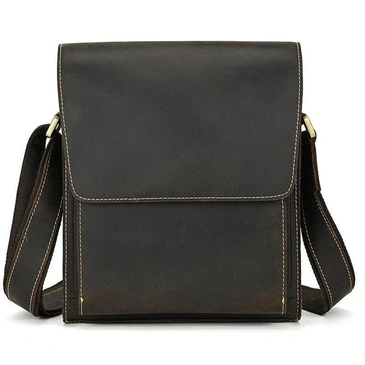 Premium leather crossbody bag with flap closure, vertical square shape, and multiple interior compartments