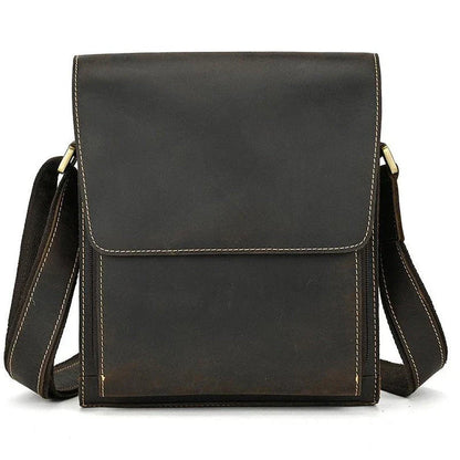 Premium leather crossbody bag with flap closure, vertical square shape, and multiple interior compartments