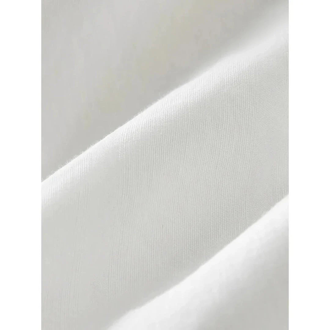 Elegant cotton and linen suspender dress with square collar neckline, A-line silhouette, and mid-calf length for a sophisticated and comfortable summer look.
