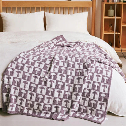 Cosy two-tone checkerboard plaid knitted throw blanket in various colours, including red, blue, grey, and purple