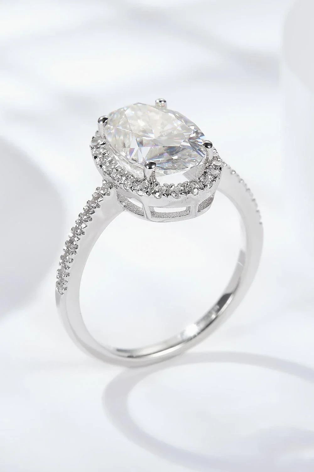 Elegant 4.5 carat moissanite halo ring in sterling silver with platinum plating, showcasing a captivating centre stone and delicate gem-studded design